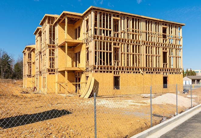 a construction site enclosed by temporary chain link fences, ensuring safety for workers and pedestrians in Bartlett TN